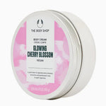 The Body Shop body cream jar with cherry blossom design on a white background