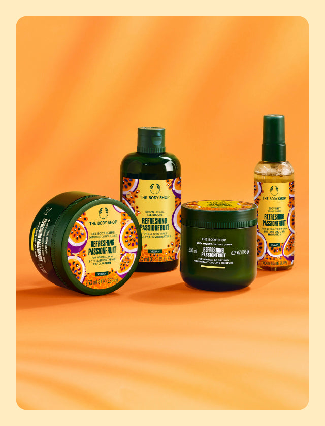 Collection of The Body Shop's Refreshing Passionfruit products on orange background