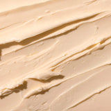 Close-up of The Body Shop's smooth, orange-y pink Sugar Pumpkin body butter spread out