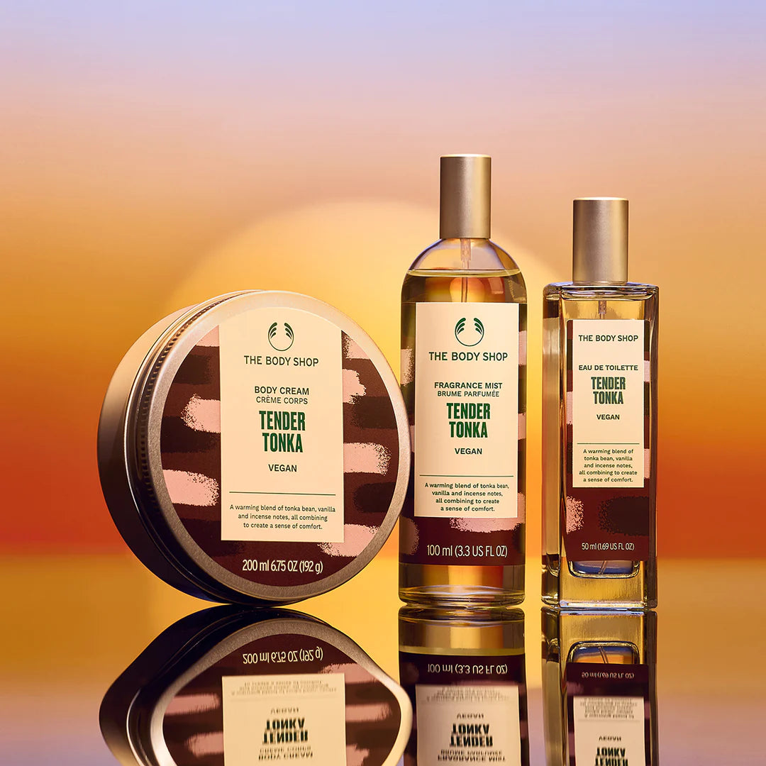 The Body Shop's Tender Tonka products on a sunset reflective background